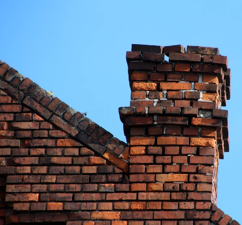 Damaged chimney on an River Oaks home showing cracks and missing mortar